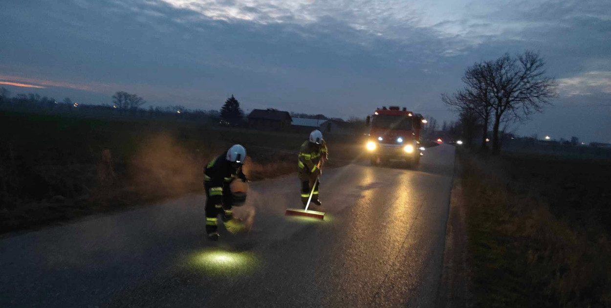 Strażacy usuwają niebezpieczną plamę oleju na drodze powiatowej w powiecie pułtuskim